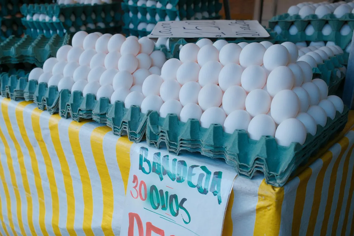 A brown egg carton at a wooden farmers market stall